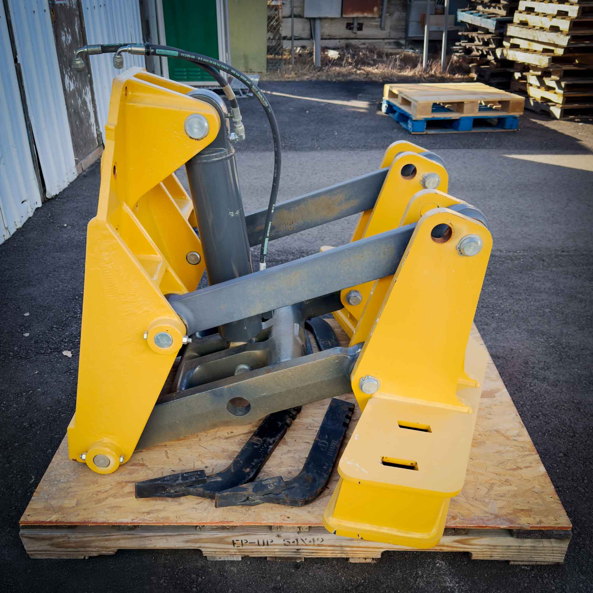 Another side view of the yellow Front Mount Scarifier for John Deere Motor Graders from Obtainium Science and Surplus, emphasizing its angled steel construction.