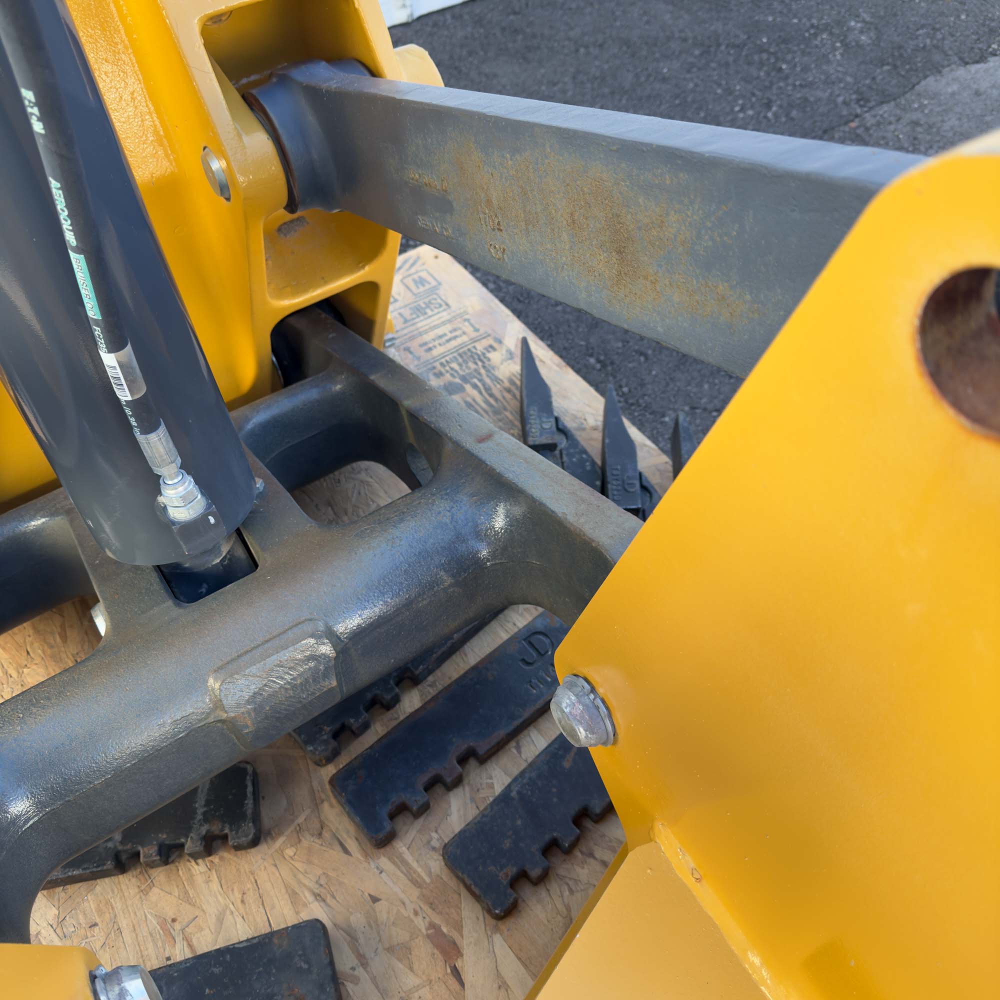 A close-up of the teeth and tines of the Front Mount Scarifier for John Deere Motor Graders from Obtainium Science and Surplus, mounted on its steel frame.